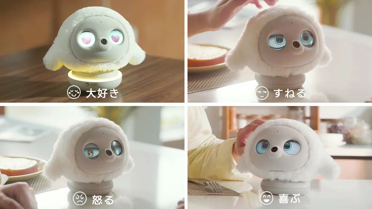 白い毛むくじゃらの可愛らしいロボットが、目と表情の変化で「大好き」「すねる」「怒る」「喜ぶ」といった様々な感情を表現している様子