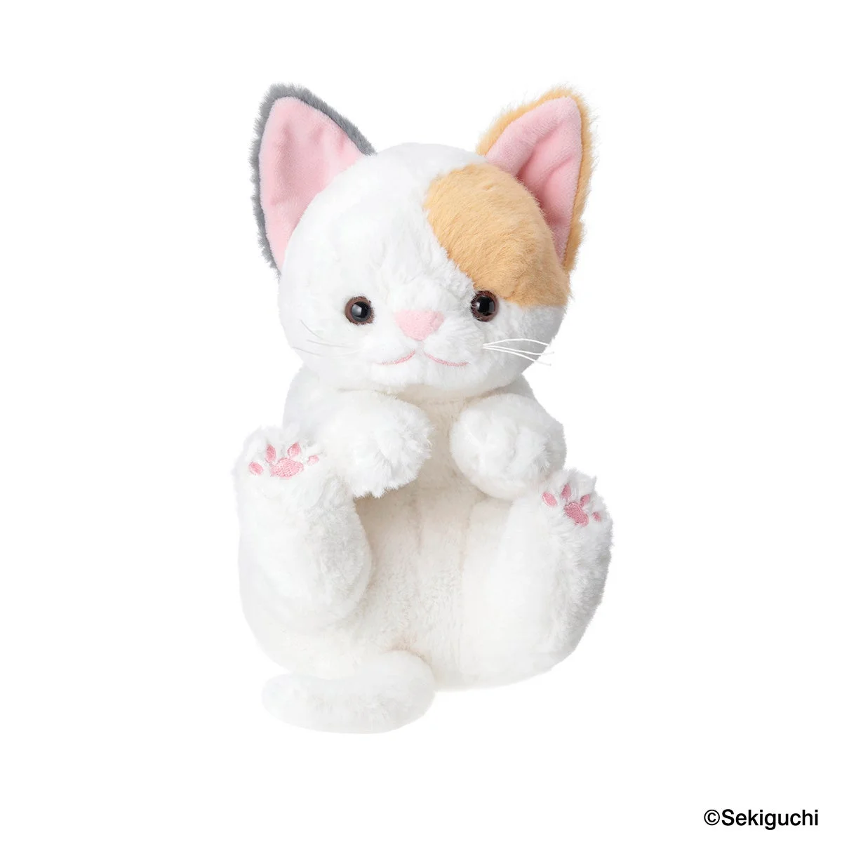 白、茶色、グレーの色合いの可愛らしい三毛猫のぬいぐるみ