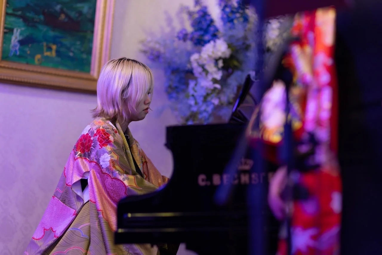 着物を着てグランドピアノを演奏する女性