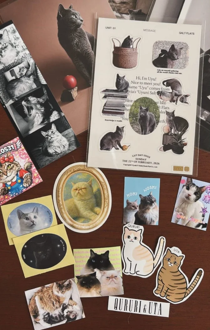 猫のステッカーや写真が並ぶ机