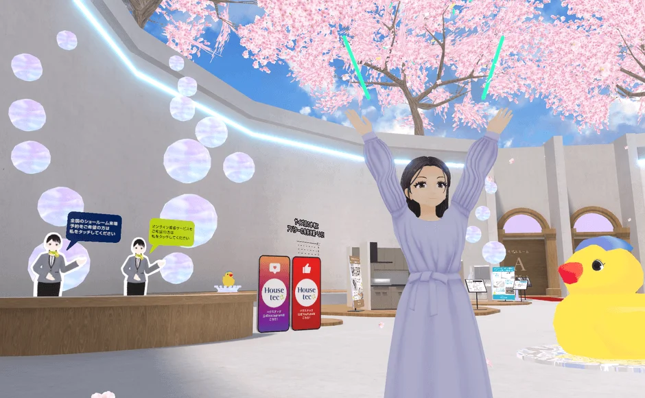 桜が咲き誇るバーチャル空間のショールームで、アバターが案内役を務める様子です。ハウステック関連の展示があり、来場予約やオンライン接客の案内がされています。