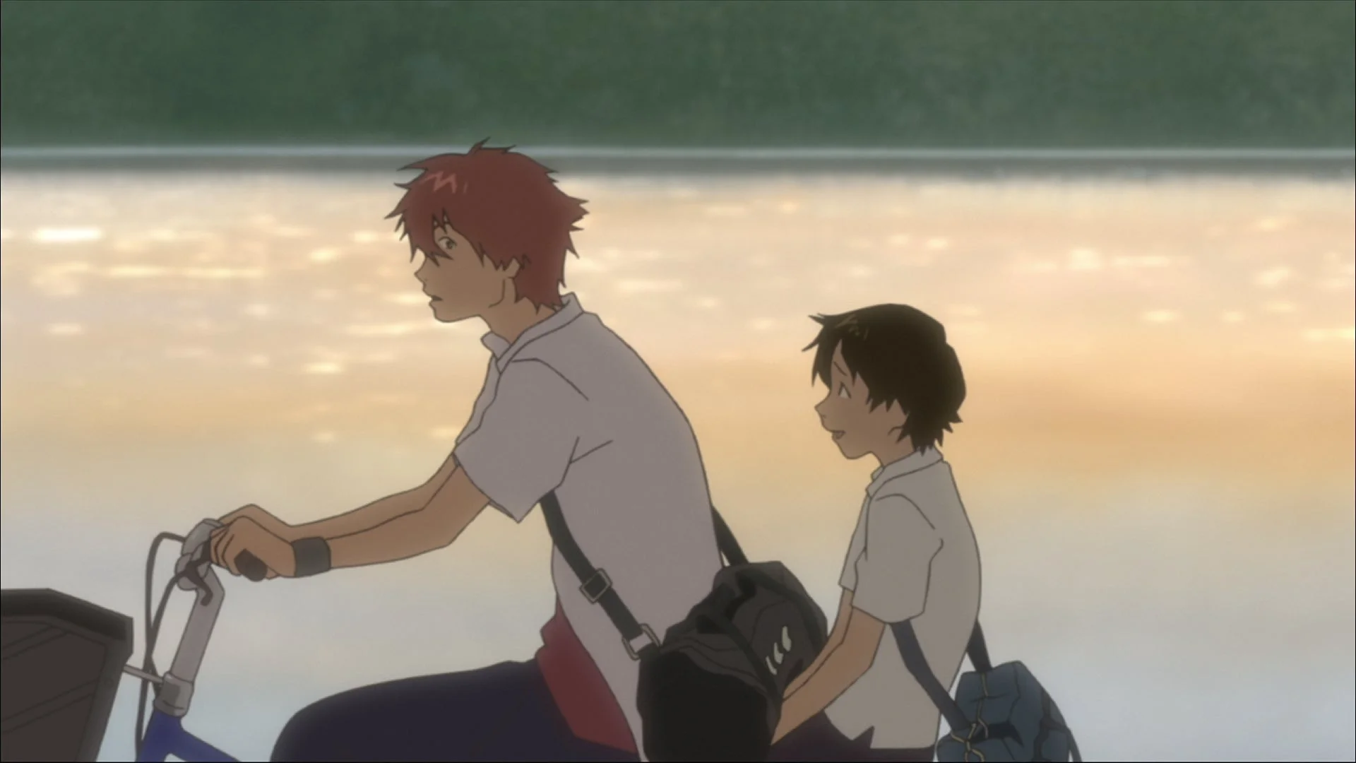 夕暮れ時、自転車に二人乗りをする少年たち