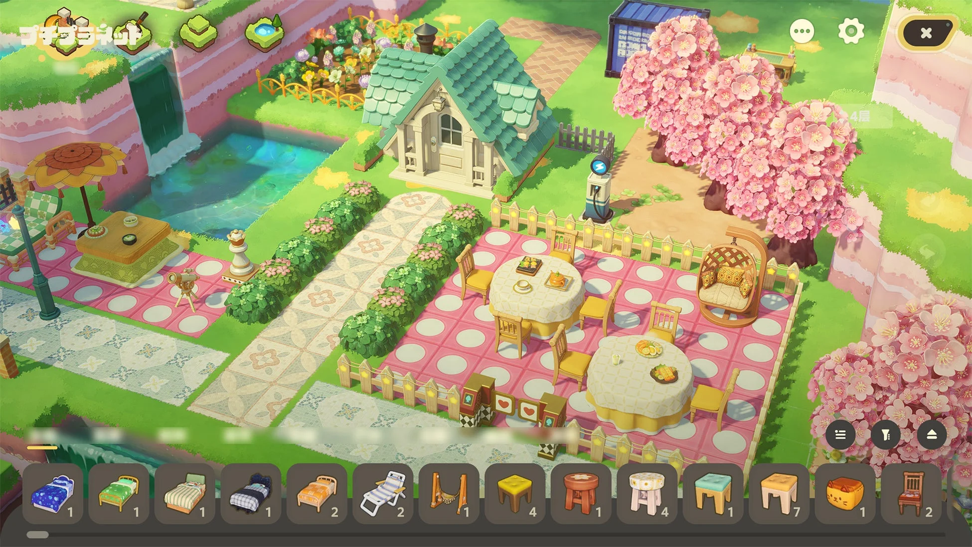 桜が咲き誇る美しい庭園に、可愛らしい家や屋外ダイニングスペースが配置された箱庭ゲームの画面