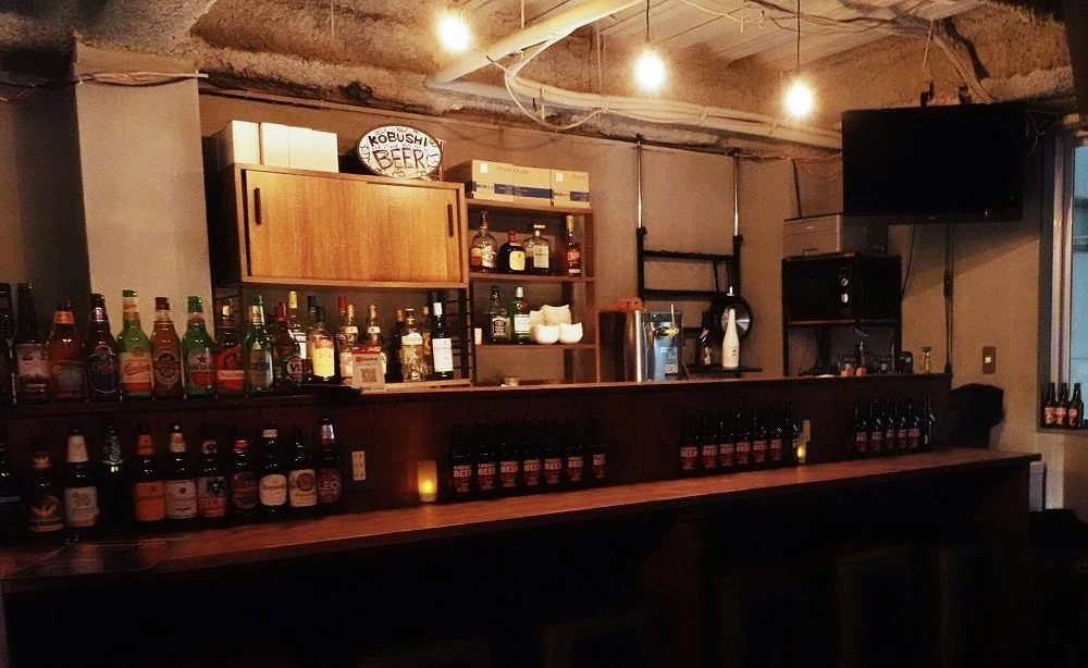 様々な種類のビールや洋酒が並べられたバーカウンター