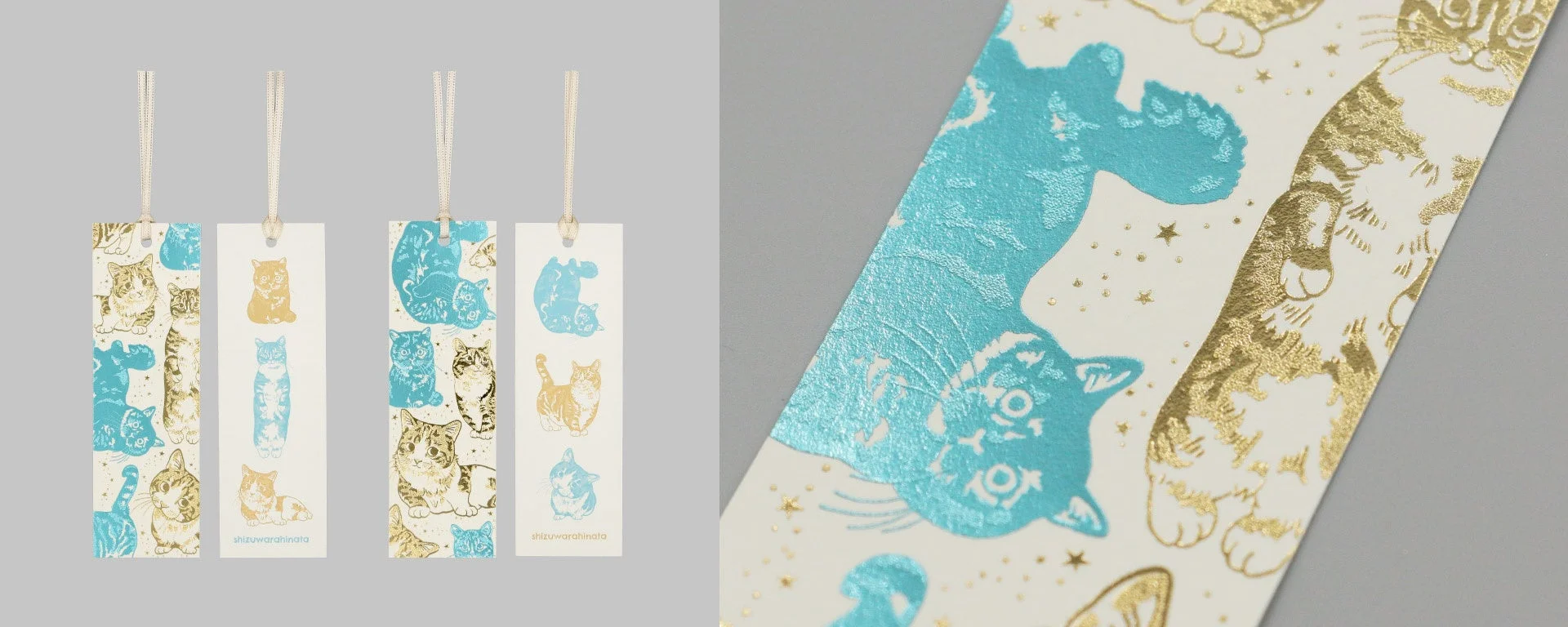 金色と水色の箔押しで様々なポーズの猫が描かれたブックマーク
