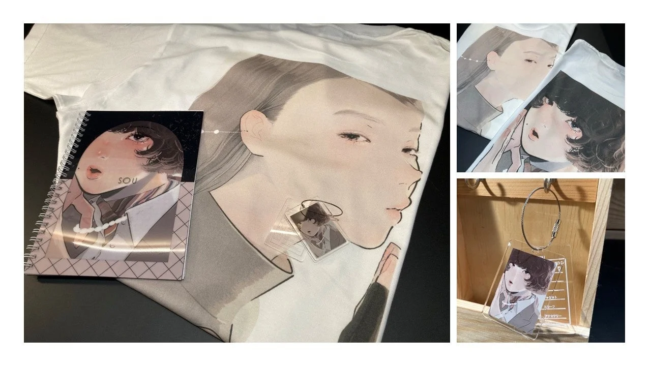 Tシャツ、ノート、キーホルダーなどのグッズに、特徴的なアニメ風の女性の顔のイラストがデザインされている様子