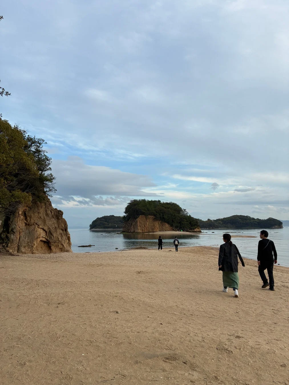 エンジェルロードのような海岸線を歩く人々