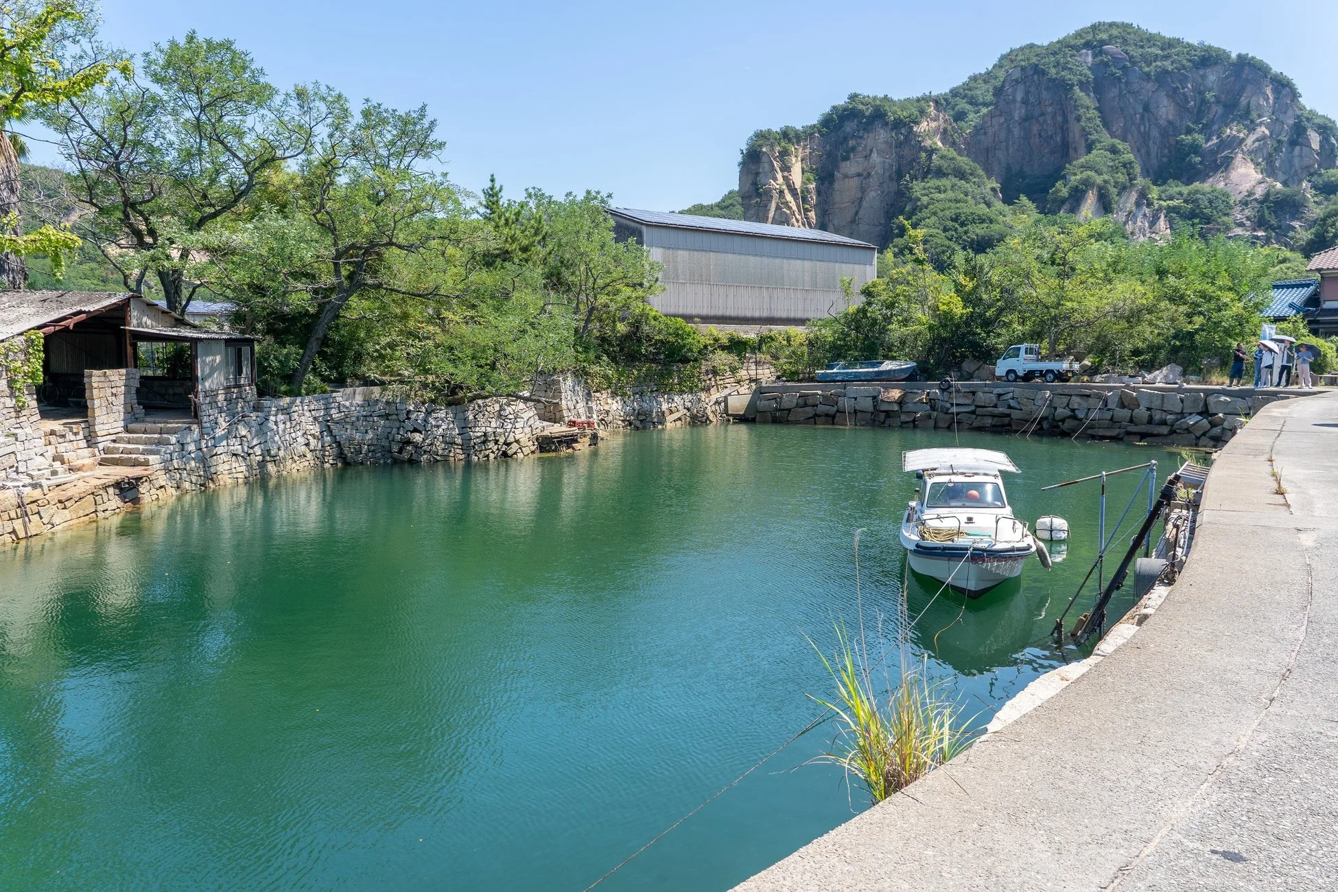 穏やかな水面にボートが浮かぶ入り江の風景
