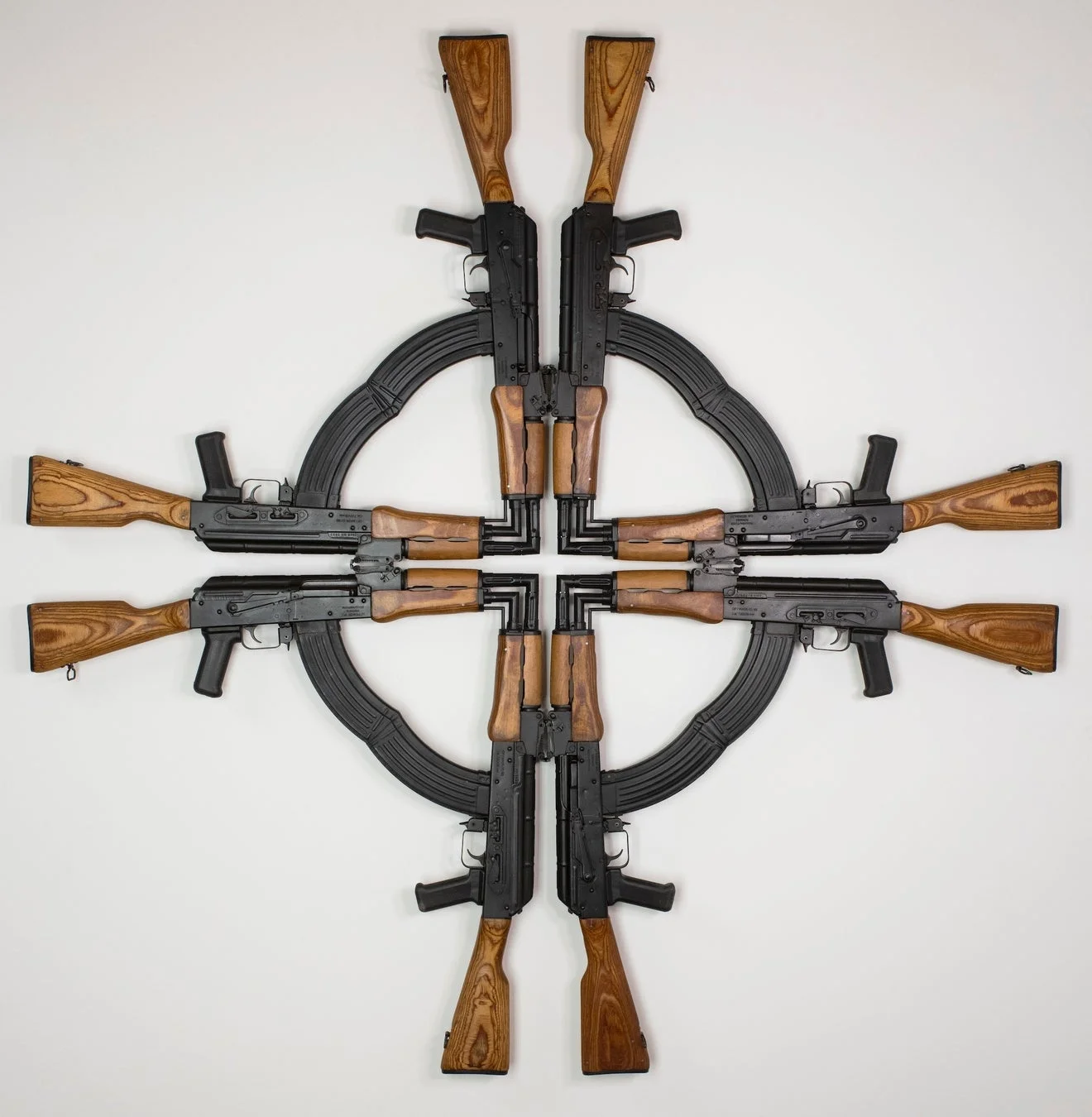 複数のAK-47型アサルトライフルが十字状に配置された現代アート