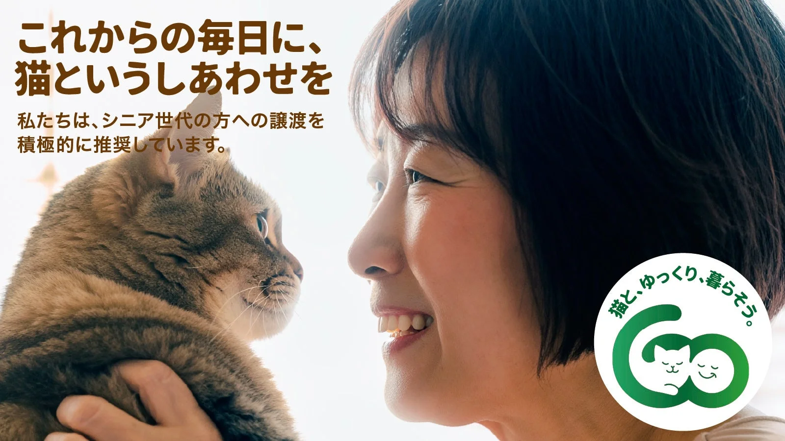 猫を抱きかかえ笑顔を見せる女性