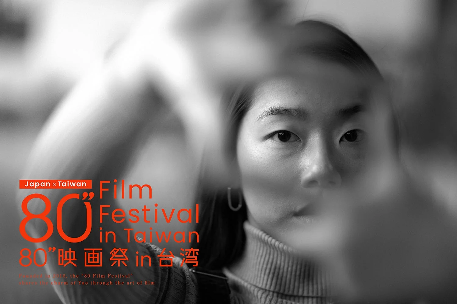 モノクロの背景に女性の顔が写り、手でフレームを作っているような映画祭のポスター